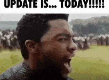 a man is screaming in front of a crowd with the words `` update is ... today ! ''