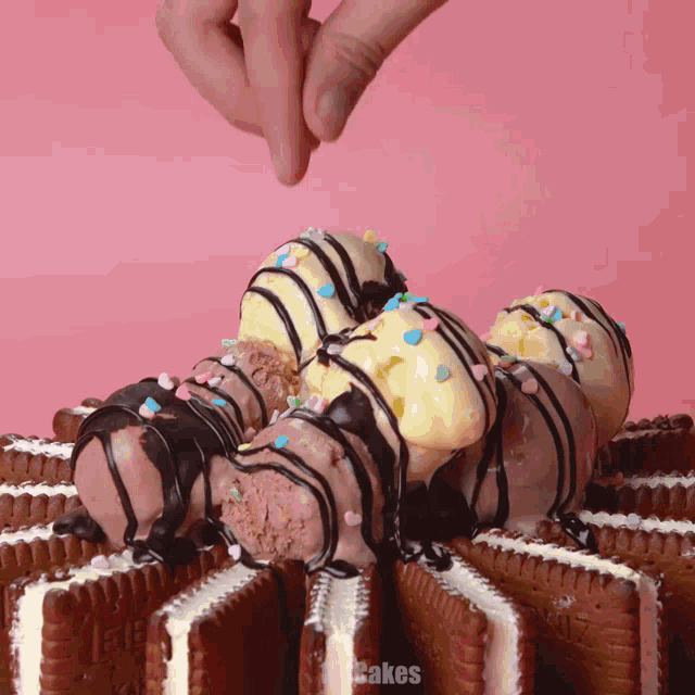 a stack of ice cream sandwiches covered in chocolate and sprinkles with cakes written on the bottom