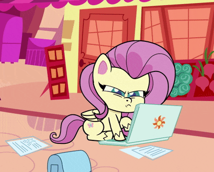 a cartoon pony is sitting at a desk using a laptop computer