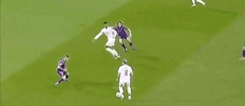 a group of people are playing soccer on a field .