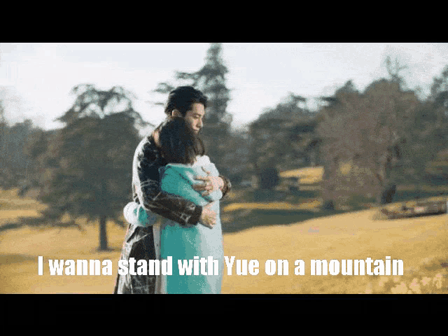 a man and woman hugging in a field with the words i wanna stand with yue on a mountain below them