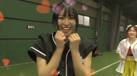 a girl in a baseball uniform is smiling in front of a wall with the number 666 on it ..