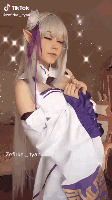 a woman in a white and purple costume has a tiktok account