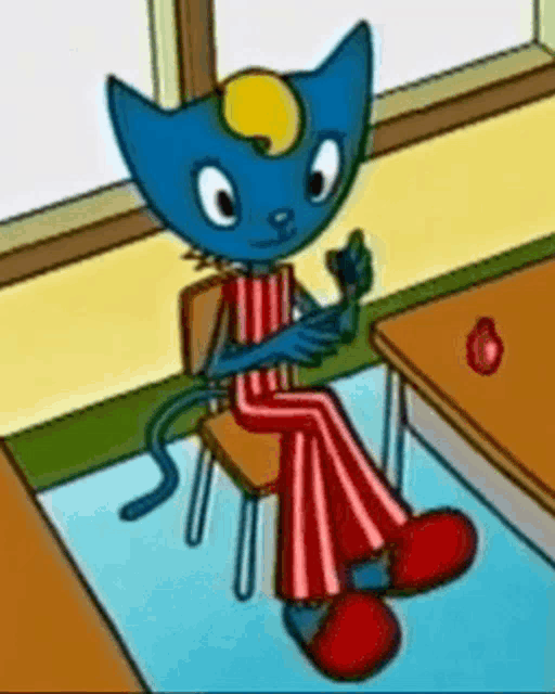 a blue cat is sitting on a chair in a room