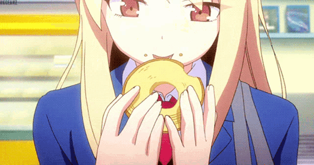 a girl in a school uniform is eating a donut with her mouth