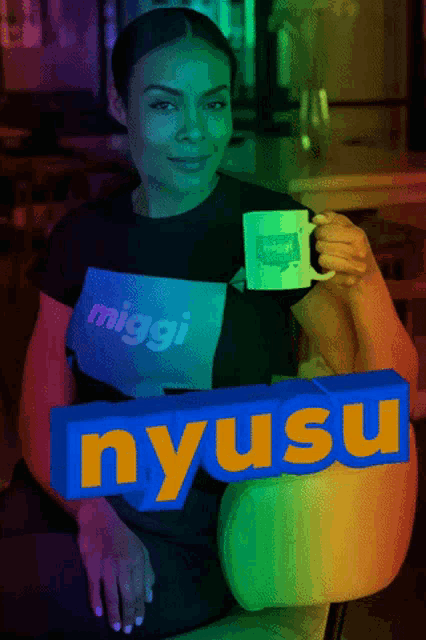 a woman wearing a miggi shirt is holding a coffee mug