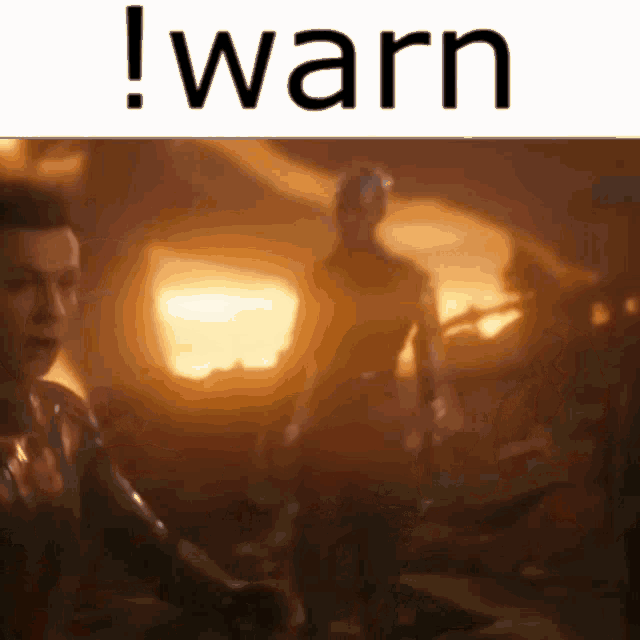a man in a suit is standing in a dark room with the words ! warn written above him .