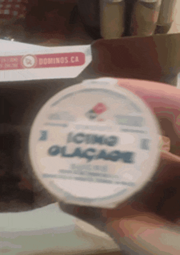 someone is holding a domino 's ice cream container in their hand