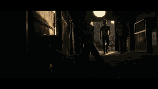 a group of men standing in a dark hallway