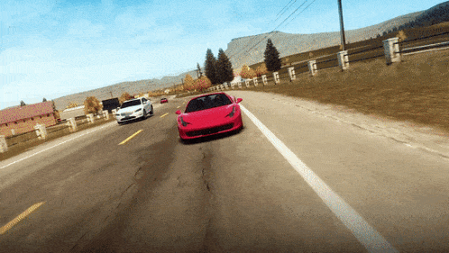 a red sports car is driving down a road