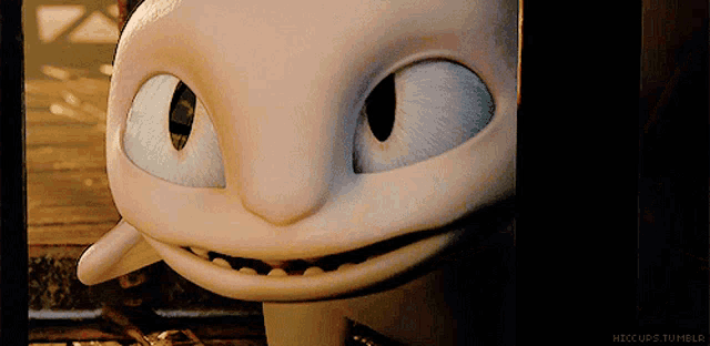 a close up of a toothless from how to train your dragon looking at the camera