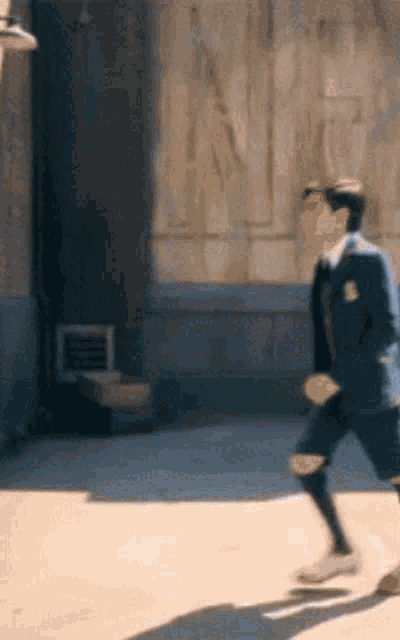 a man in a suit is running down the street .
