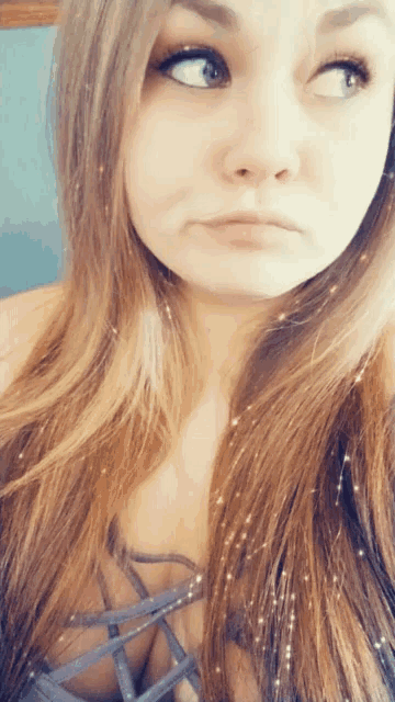 a close up of a woman 's face with her eyes looking up