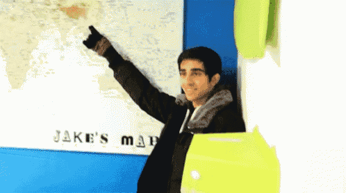 a man stands in front of a map that says " jake 's map "
