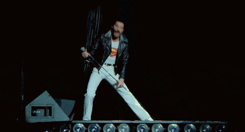 a man in a leather jacket is running on a stage in front of a speaker that says ip65