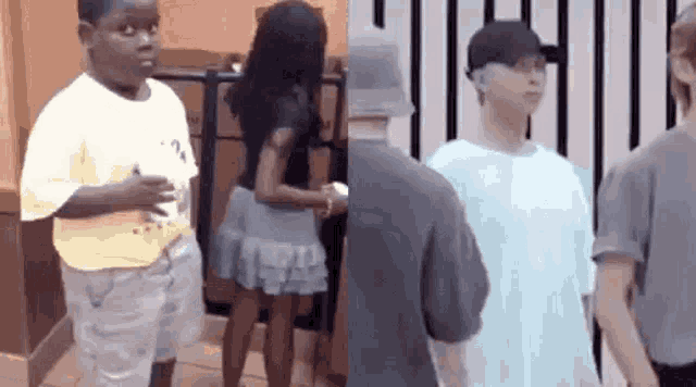 a boy and a woman are standing next to each other in a room .