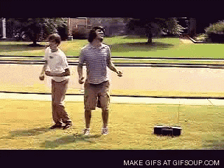 two men are dancing in front of a radio that says make gifs at gifsoup.com on the bottom right