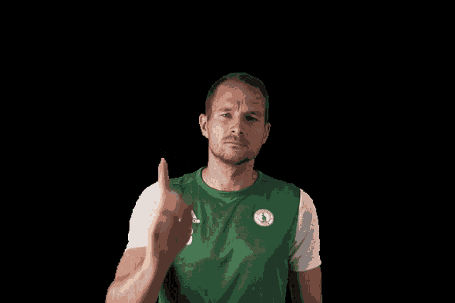 a man wearing a green adidas shirt with the number 3