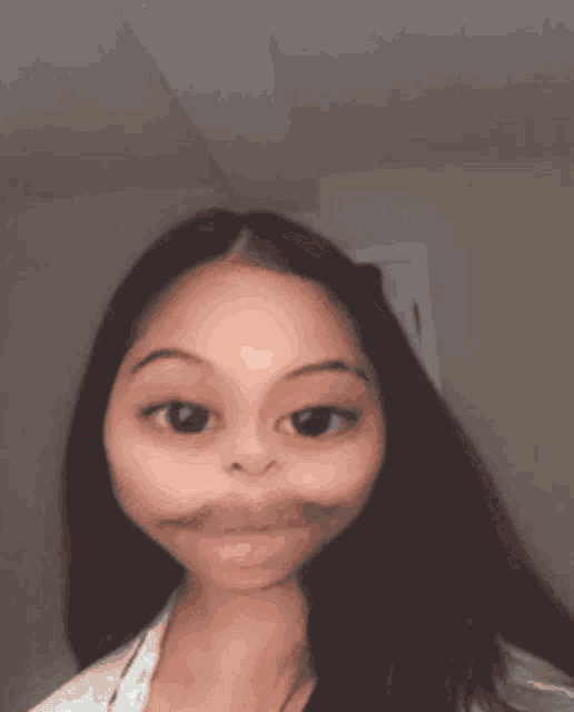 a girl with a cartoon face is looking at the camera