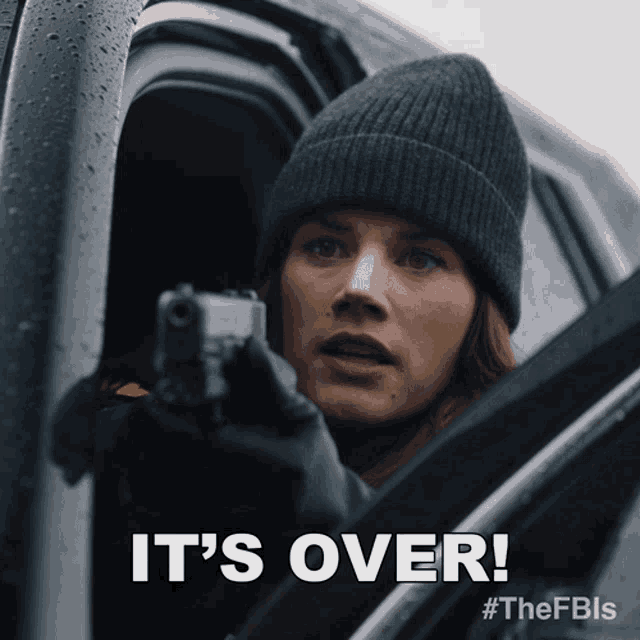 a woman holding a gun with the words " it 's over " below her