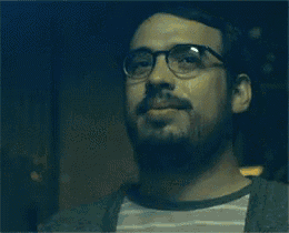a man with glasses and a beard is crying with a tear coming out of his eye