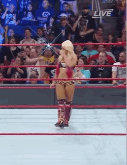 a woman in a wrestling ring with the word live on the bottom