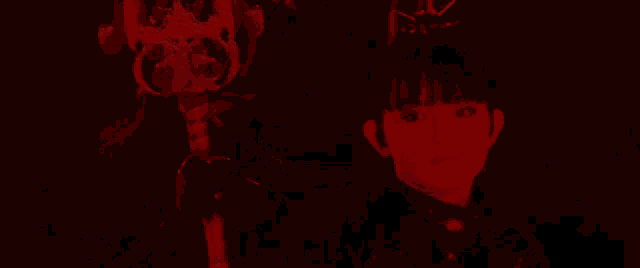 a woman in a dark room with a red light behind her