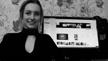 a woman is smiling in front of a computer screen that says pornhub on it .