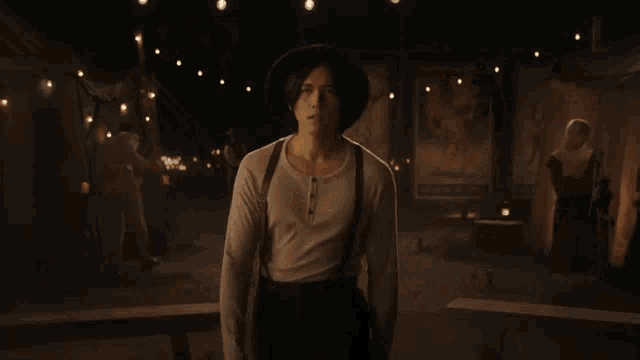 a woman in a white dress is standing in a room