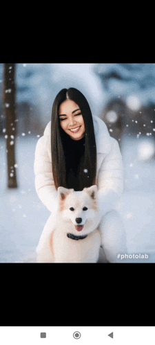 a woman in a white coat holds a white dog in the snow