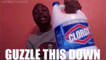 a man is standing next to a gallon of clorox .