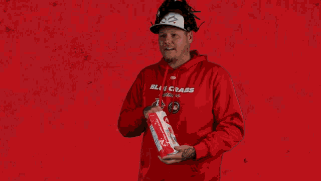 a man wearing a red shirt that says black crabs