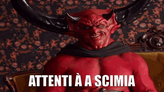 a devil with horns is sitting on a couch with the words attenti a a scimia above him
