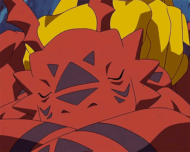 a person is petting a red and yellow monster