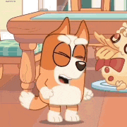 a cartoon dog is standing next to a stuffed animal on a table .