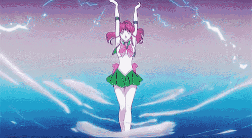 a girl with pink hair and a green skirt is standing in the water with her arms in the air .