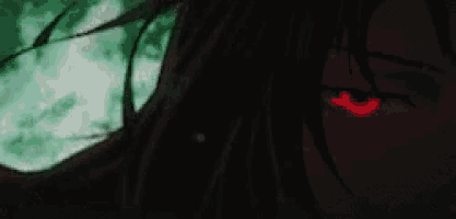 a close up of a person 's face with a red eye in the dark .