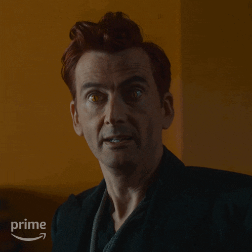 a close up of a man 's face with the word exactly in the upper right corner