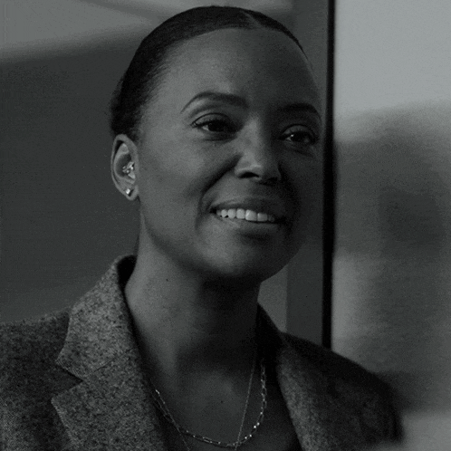 a black and white photo of a woman in a suit