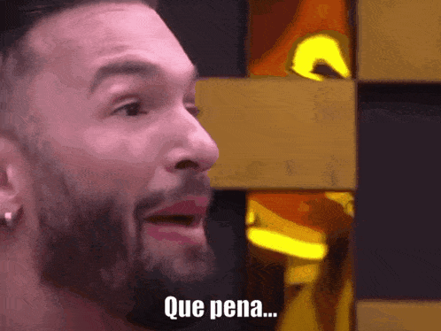 a close up of a man 's face with que pena written on it