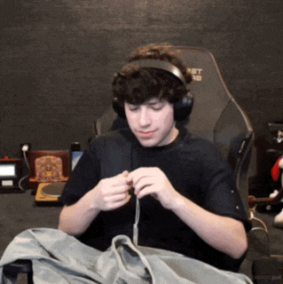 a man wearing headphones sits in a chair that says pet pro