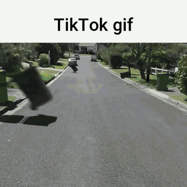 a gif of a person riding a bike down a street with the words " tiktok gif " at the top