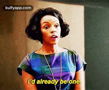 a woman in a blue and purple dress is talking and says i 'd already be one .