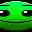 a close up of a green frog 's face with a blurred background .