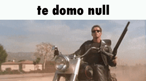 a man is riding a motorcycle while holding a gun in his hand .