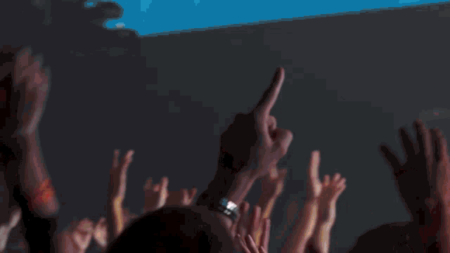 a man singing into a microphone in front of a sign that says a mighty warrior consuming fire