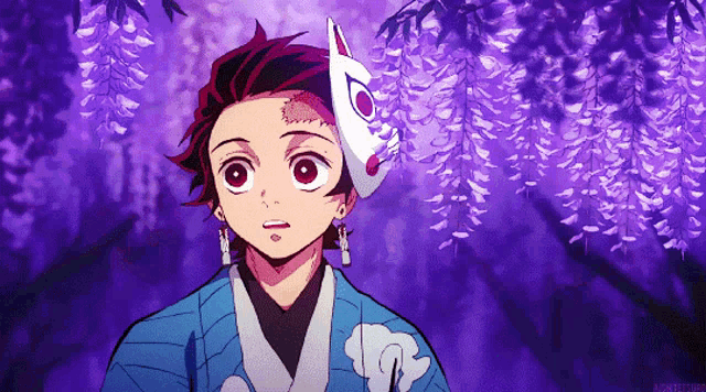 a boy with a fox mask on his head is standing in front of purple flowers .