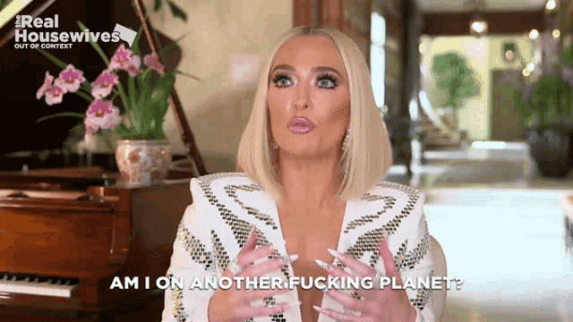 a woman says " am i on another fucking planet " while standing next to a piano