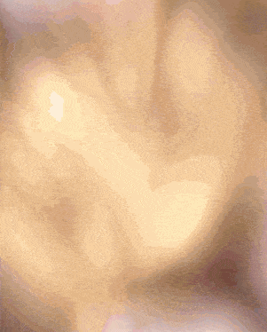 a blurred image of a person 's face with a few spots of light on it
