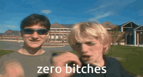 two men wearing sunglasses are standing next to each other and one of them is saying zero bitches .